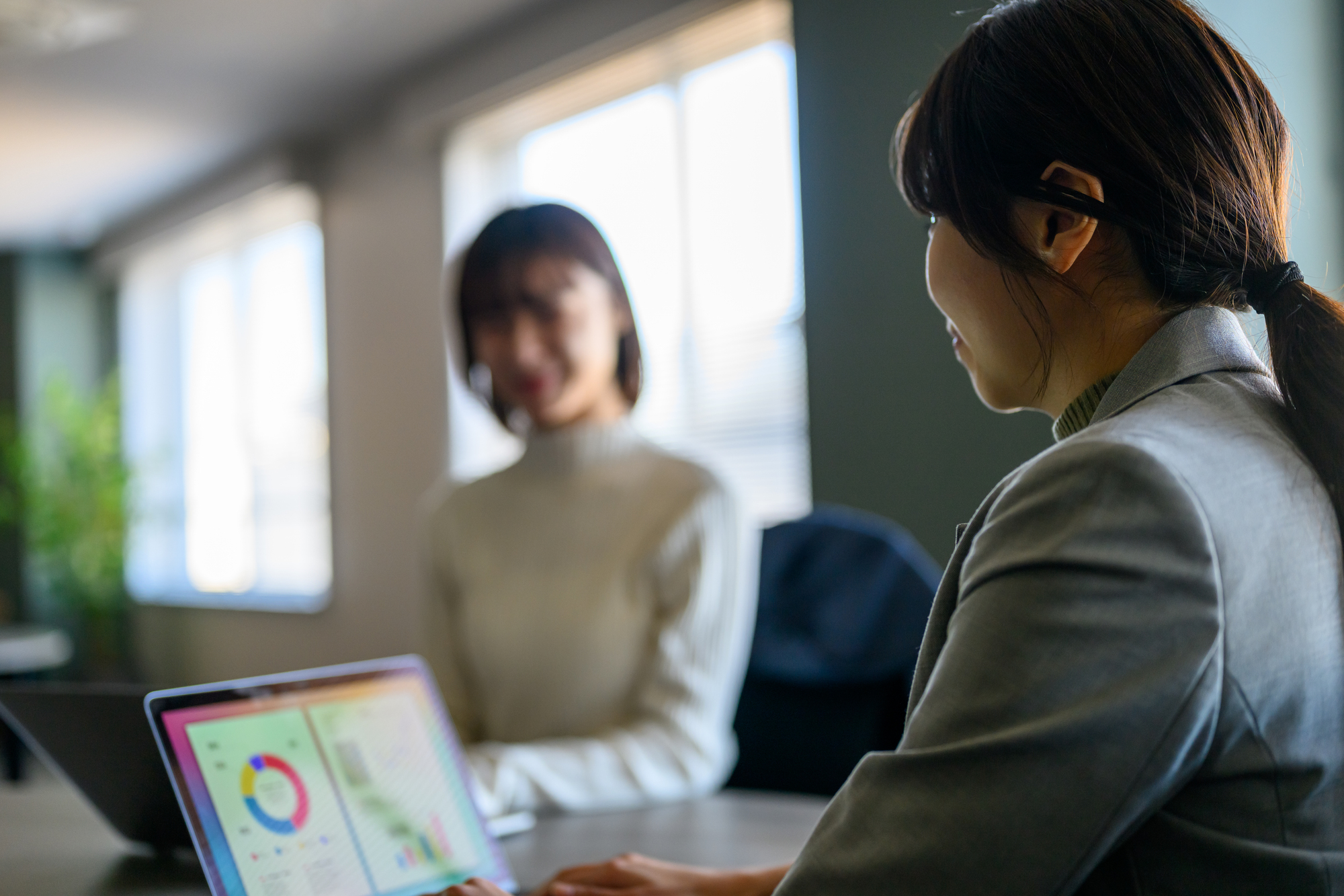 Business professionals reviewing data during a payroll consultation