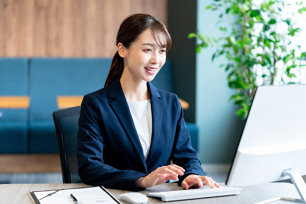 Japanese office professional working at a computer